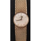Omega, a ladies 9ct gold wristwatch the dial with raised baton numerals,
