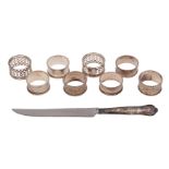 A collection of eight silver napkin rings,