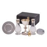 A late Victorian silver matched travelling communion set, comprising a cup and paten,