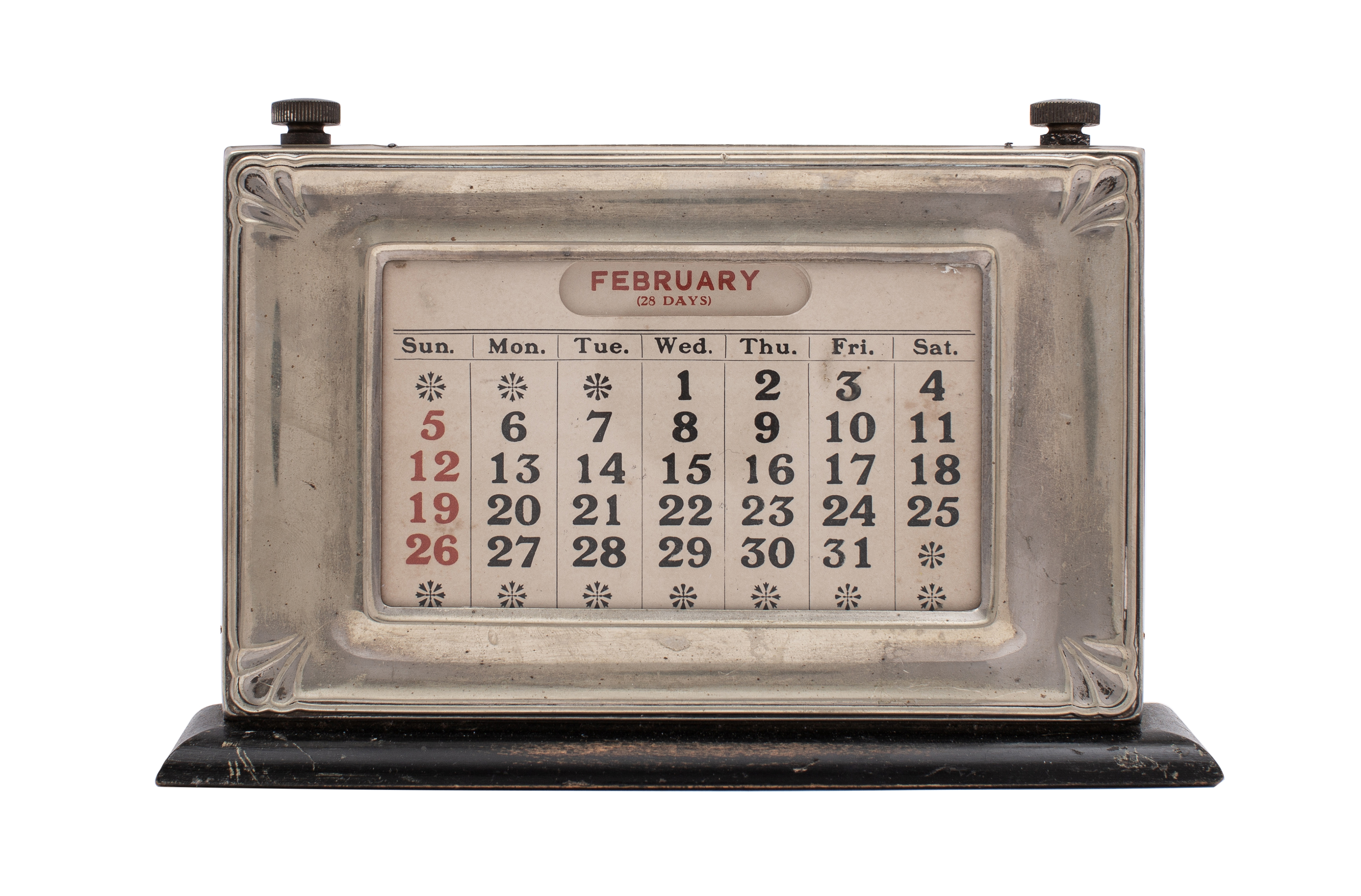An EPNS mounted perpetual desk calendar on ebonised plinth, 21.5cm long.