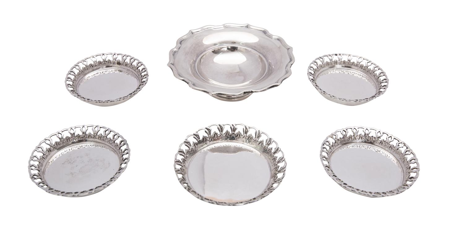 A set of five Egyptian silver coasters, stamped marks with pierced borders, 9cm and 7.