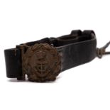 A late 19th century Royal Navy regulation black leather waist belt: the clasp with Queen's Crown.