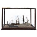 A late 19th century cased diorama of sailing vessels: comprising a white hulled three masted ship,