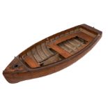 An early 20th century apprentice model of a clinker built dinghy: plank and pinned hull with