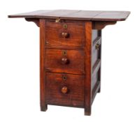 A mahogany cabin table: the fold down top raised on a central pedestal fitted three short drawers,