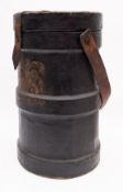 An early 20th century black canvas charge or shot container: with brown leather strap and handle,