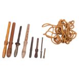 A group of various belaying pins: comprising an iron example and three wooden pins,