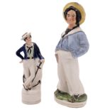 A 19th century Staffordshire figure of a second or third class boy: dressed in straw hat,