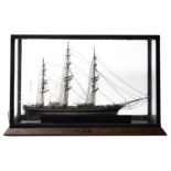 A cased scale model of the Cutty Sark standing and running rigged over decks with lifeboats,