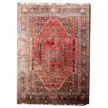 An Afghanistan carpet, the rose stepped and serrated hexagonal field with a central pole medallion,