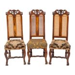 A set of three carved walnut dining chairs in William and Mary style,