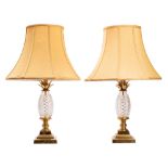 A pair of cut glass and gilt metal mounted table lamps,