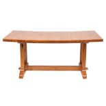 A stained molave wood trestle table,