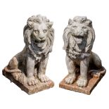 A pair of painted stone composition garden models of lions,