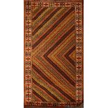 A Turkomav rug, the serated chevron design field enclosed by a hooked cruciform border,