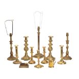 A collection of mixed brass domestic wares includes;- table lamps, candlesticks,