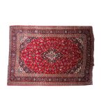 A Kashan carpet, the wine field with a central indigo cartouche pole medallion,