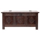 A 17th century oak coffer, with hinged cover above a frieze of anthemia filled arches,