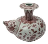 A Chinese porcelain Kendi of squat form with flaring neck and bulbous spout painted in copper red