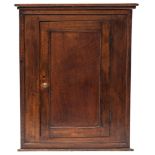 A George III oak hanging corner cupboard,