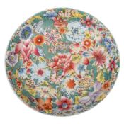 A Chinese famille rose millefleur saucer dish enamelled overall with colourful flowers and foliage,