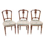 A set of six Victorian carved walnut salon chairs,