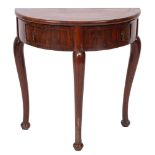 A George II walnut demi-lune side table, mid 18th century; with cross banded top,