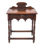 A late Victorian carved oak rectangular side table with shaped ledge back and C-scroll panel,