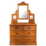 An Edwardian satin beech dressing table chest,