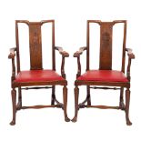 A pair of Edwardian oak open armchairs,