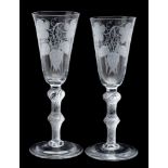 A pair of ale glasses engraved with hops and barley, on double knopped air twist stems, 20cm.