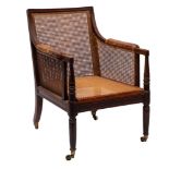 A Regency mahogany and canework library bergere armchair,