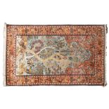 A Kashmir silk prayer rug, the pastel blue mihrab with a tree of life design,