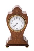 A Edwardian mahogany balloon clock the French eight-day duration movement having a platform lever