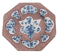 An English delft octagonal plate, painted in blue with shaped panels containing a bird,