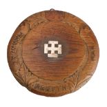 A carved oak and silver mounted Winchester College bread board,