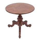 A circular low occasional table with a mahogany top,