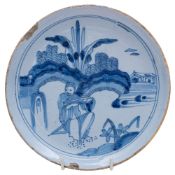 A late 17th century English blue and white delftware saucer dish painted and trecked with a