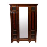 A Victorian mahogany, ebonised and amboyna veneered wardrobe in Aesthetic Movement style,