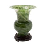 A Chinese jade Gu-form vase the stone of spinach green colour with grey inclusions,