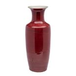 A large Chinese copper-red baluster vase the glaze falling short at the flared rim,