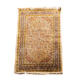 A Kashmiri rug, the ivory cartouche field with a central powder blue cartouche pole medallion,