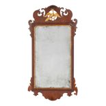 A George III mahogany and partly gilt fret carved mirror with pierced ho-ho bird cresting,