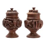 A pair of Eastern Asian 'dragon' jars and covers carved in high relief with mythical beasts, 22cm.