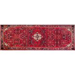 A Hamadan rug, second half 20th century; with flowers and foliage in a central ivory medallion,