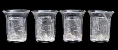 Four Lalique 'Les Enfants' liqueur or shot glasses each with a frosted and moulded panel depicting