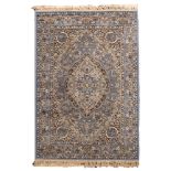 A machine made rug of Kashan design, with a pastel blue field and cartouche pole medallion ,