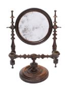 A Regency turned and ebonised mahogany shaving mirror,