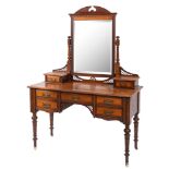 An Edwardian mahogany dressing table with rectangular swing mirror,