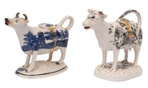 A Cambrian pottery cow creamer and cover and a Staffordshire cow creamer and cover the first